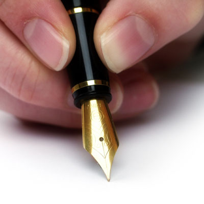 close-up of someone writing with a fountain pen