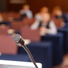 microphone on blurred meeting audience
