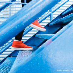 picture of someone in bright red running shoes climbing stairs